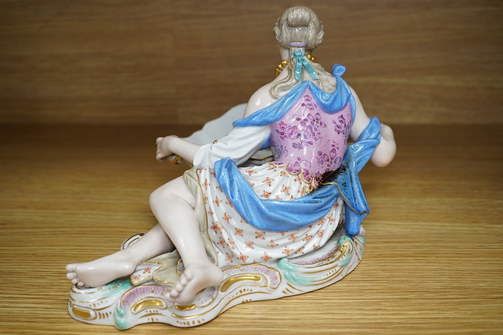 A Meissen female figural dish, 27cm wide. Condition - dish damaged (pieces in bag), crack near front knee